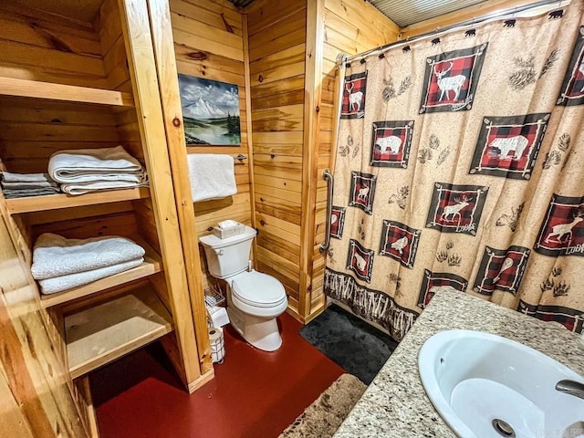 bathroom featuring vanity, toilet, wooden walls, and walk in shower