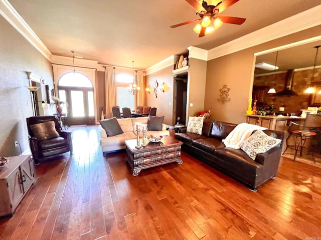 living room with ornamental molding, hardwood / wood-style floors, and ceiling fan with notable chandelier