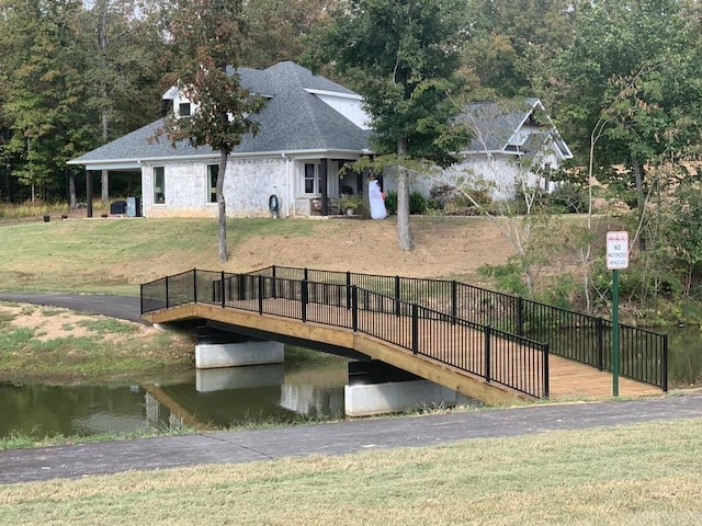 view of dock featuring a yard and a water view