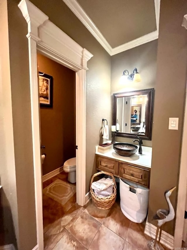 bathroom featuring vanity, crown molding, toilet, and tile patterned flooring