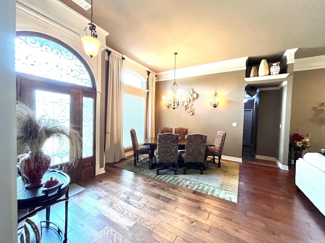 dining room featuring ornamental molding, a notable chandelier, and dark hardwood / wood-style flooring