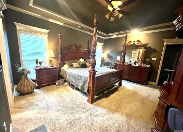 bedroom featuring crown molding, light carpet, multiple windows, and ceiling fan