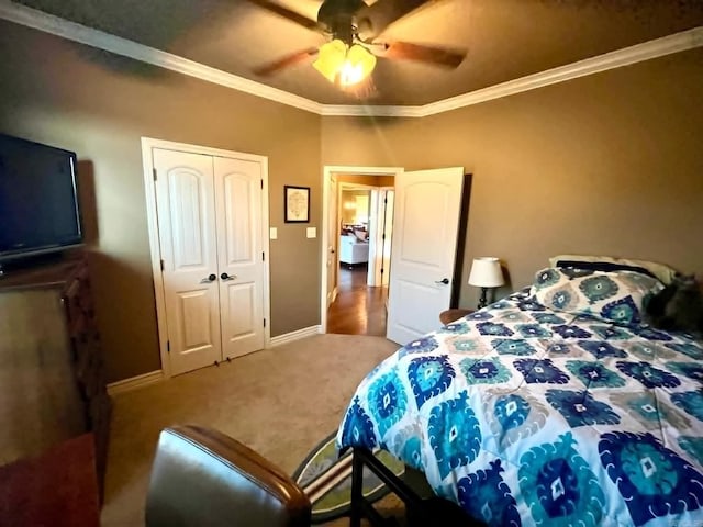 carpeted bedroom with crown molding, a closet, and ceiling fan