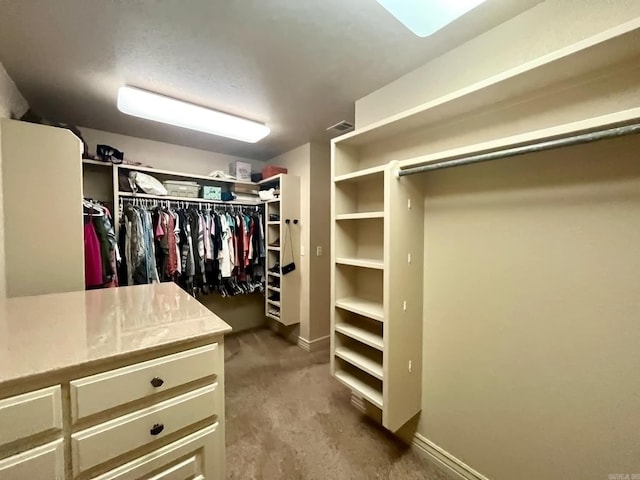 walk in closet featuring carpet flooring