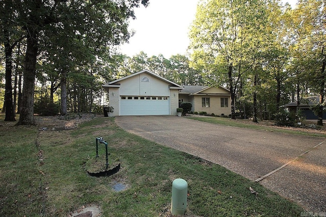 ranch-style house featuring a garage and a front yard