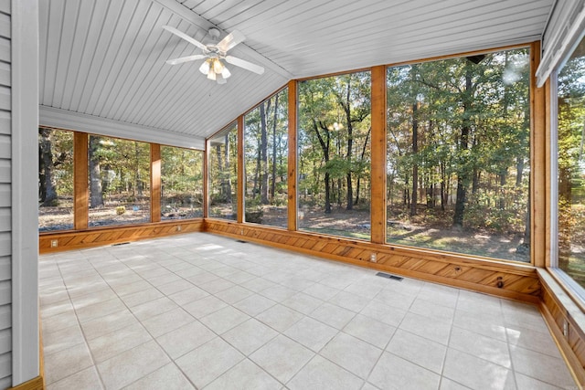 unfurnished sunroom featuring visible vents, a ceiling fan, and vaulted ceiling