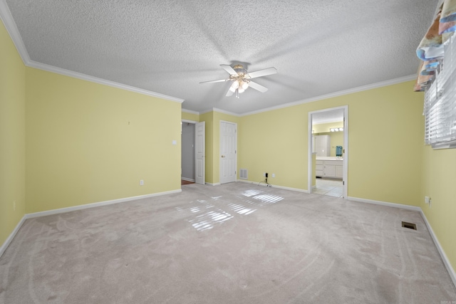 unfurnished bedroom featuring carpet floors, ornamental molding, baseboards, and visible vents