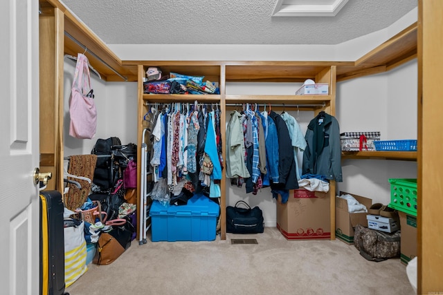 walk in closet with carpet flooring