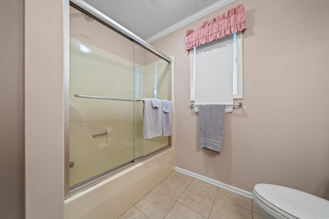 full bath with tile patterned flooring, toilet, a textured ceiling, baseboards, and bath / shower combo with glass door