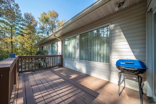 wooden terrace featuring a grill