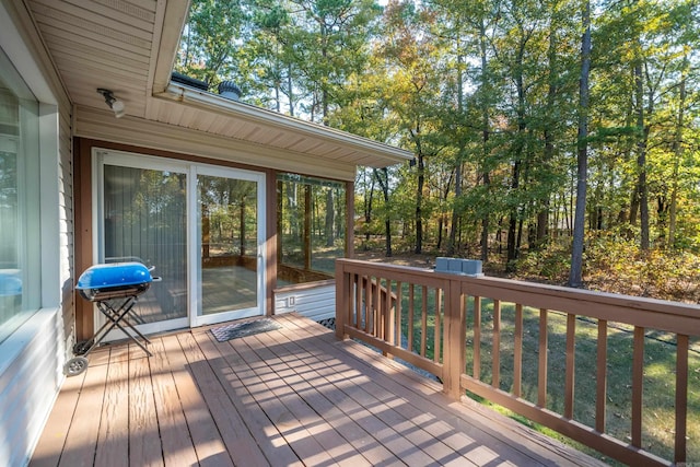 wooden deck with a grill