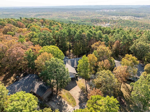 bird's eye view with a wooded view