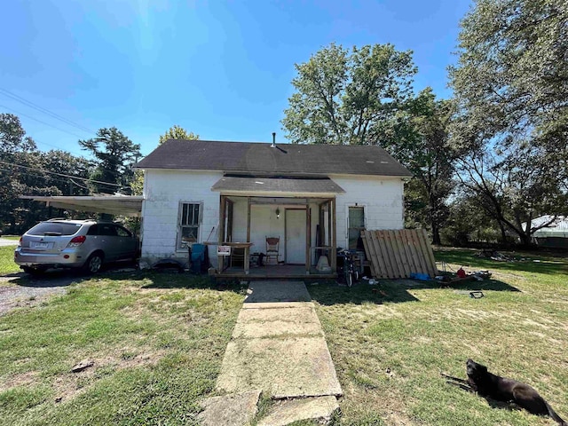 bungalow-style home with a front yard and covered porch