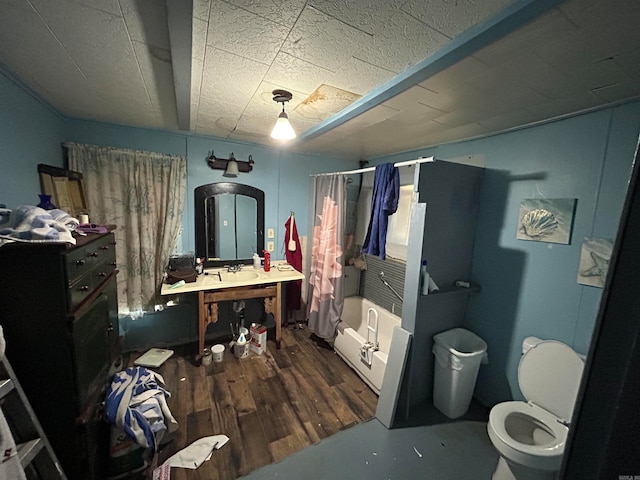 bathroom with toilet, shower / tub combo, and wood-type flooring