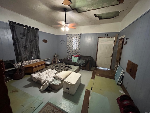 miscellaneous room featuring wood walls and ceiling fan