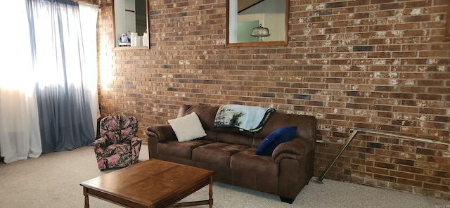 living area with light colored carpet and brick wall