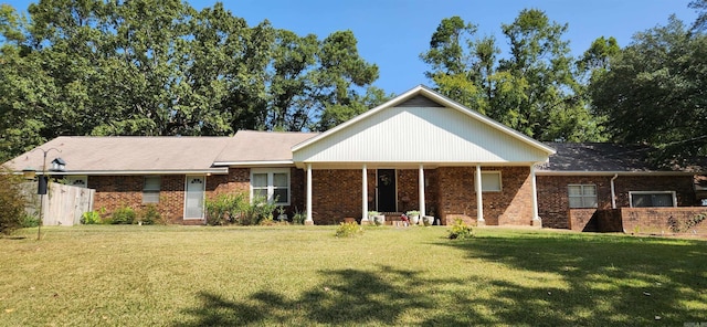 view of front of house with brick siding and a front lawn