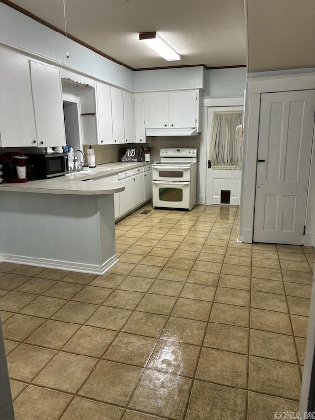 kitchen featuring white electric stove, sink, kitchen peninsula, and white cabinets