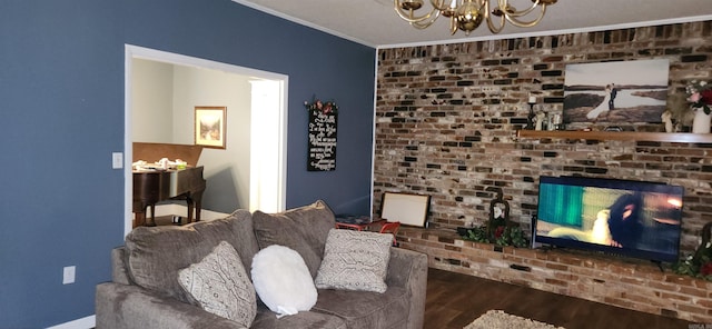 living room featuring crown molding, wood-type flooring, a chandelier, and a fireplace