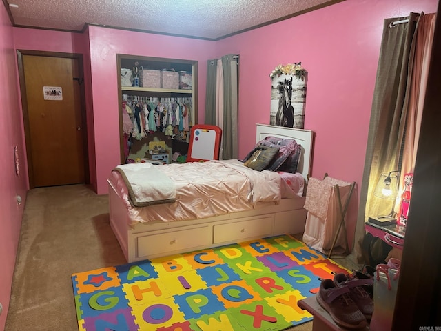 bedroom with a closet, carpet floors, and a textured ceiling