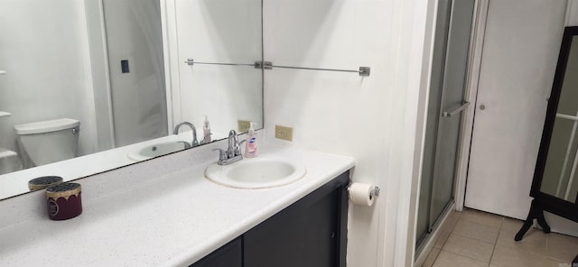 bathroom featuring tile patterned flooring, walk in shower, toilet, and vanity