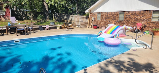 view of pool with a fenced in pool, a patio, and fence