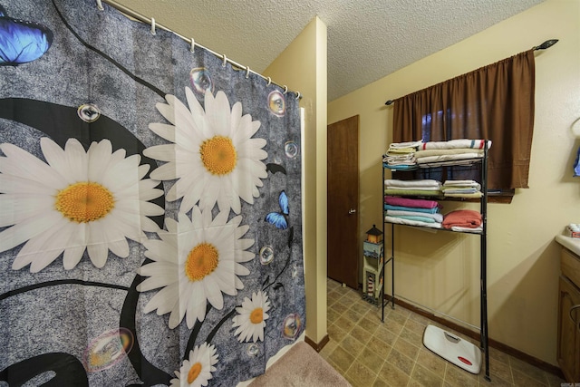 bathroom with vanity, a textured ceiling, and a shower with shower curtain