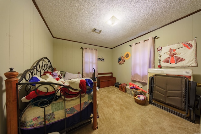 carpeted bedroom featuring crown molding and a textured ceiling