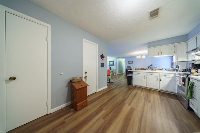 kitchen featuring a textured ceiling, pendant lighting, white cabinetry, hardwood / wood-style flooring, and electric stove