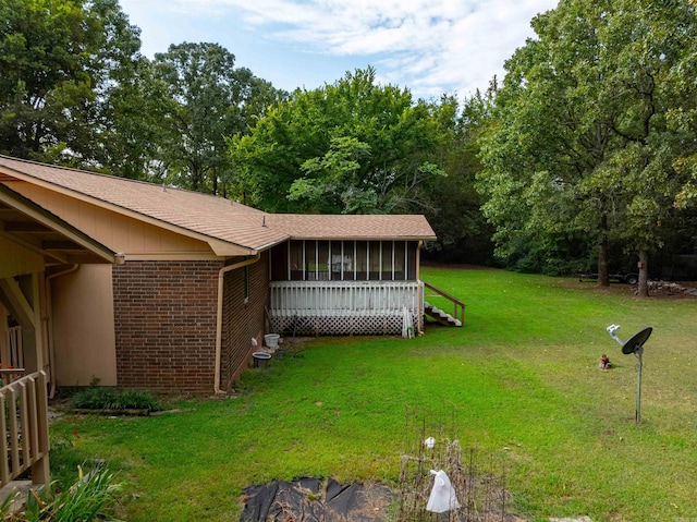 view of yard with a sunroom