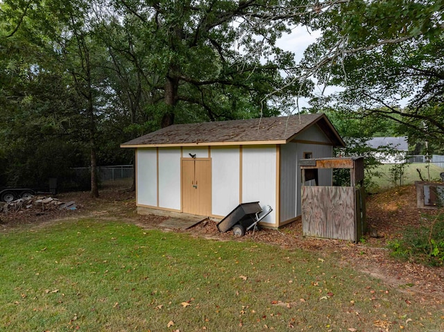 view of outdoor structure featuring a lawn