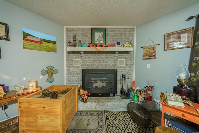 tiled living room with a textured ceiling and a brick fireplace