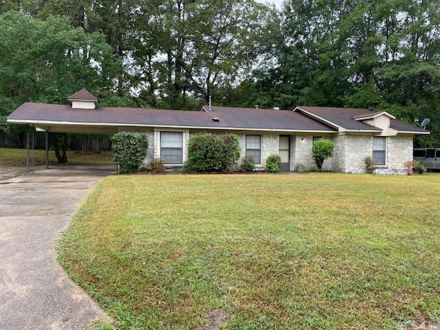 ranch-style house with a front yard and a carport