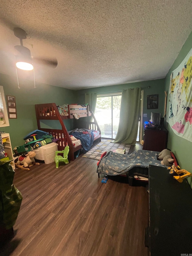 bedroom with ceiling fan, a textured ceiling, and hardwood / wood-style floors