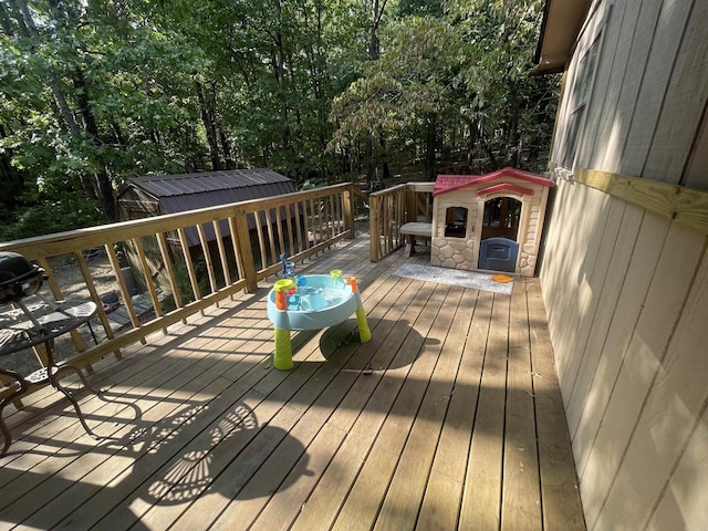 wooden deck with a storage shed