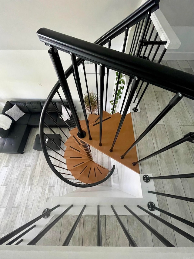 stairway featuring hardwood / wood-style floors