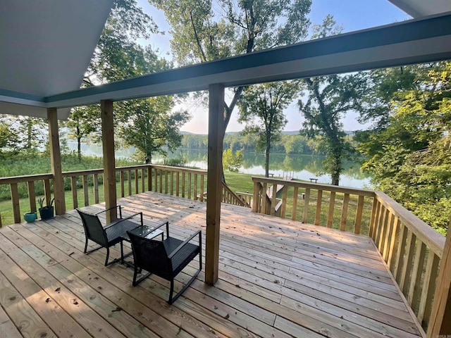 wooden terrace featuring a water view