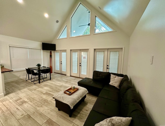 living room featuring ceiling fan, french doors, high vaulted ceiling, and light hardwood / wood-style floors