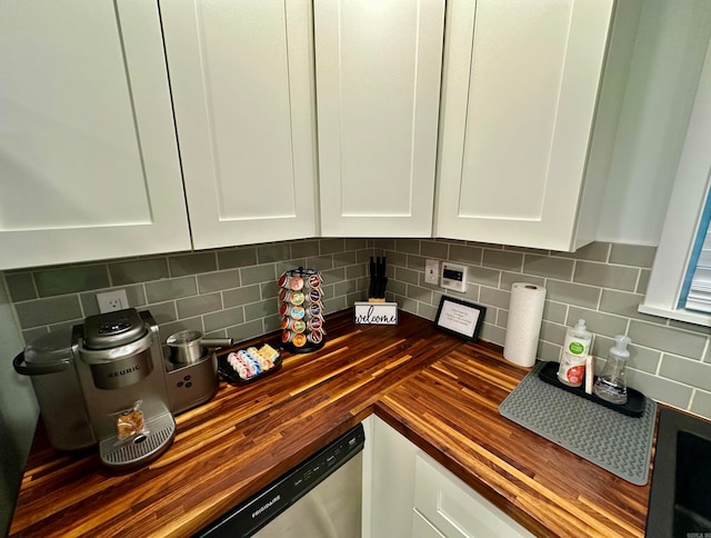 kitchen with backsplash, white cabinetry, and wooden counters