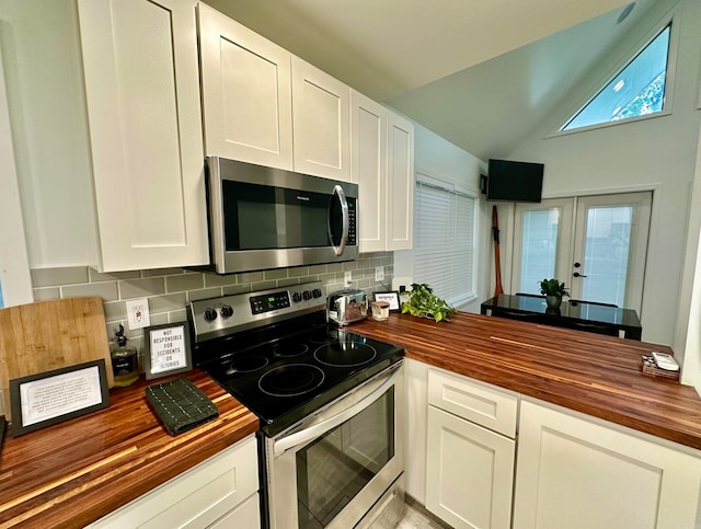 kitchen featuring wood counters, stainless steel appliances, and white cabinets