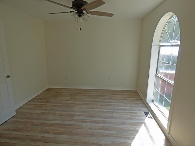 unfurnished room with light wood-type flooring and ceiling fan