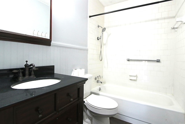 full bathroom with tiled shower / bath, vanity, and toilet