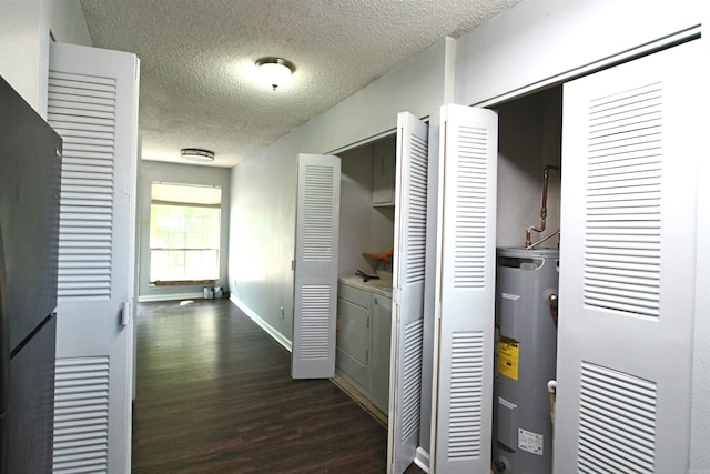 hall with a textured ceiling, dark wood-type flooring, and water heater