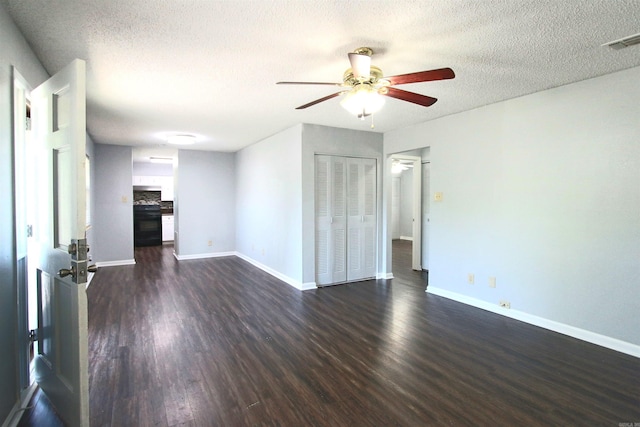 unfurnished living room with dark hardwood / wood-style flooring, ceiling fan, and a textured ceiling