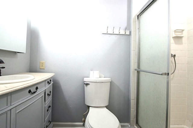 bathroom featuring vanity, toilet, and walk in shower