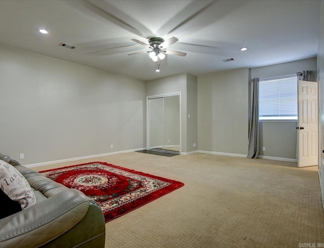 interior space with ceiling fan and carpet floors