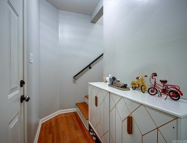 stairs featuring hardwood / wood-style flooring