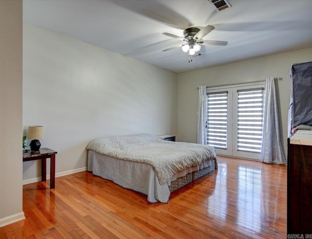 bedroom featuring ceiling fan, light wood-type flooring, and french doors