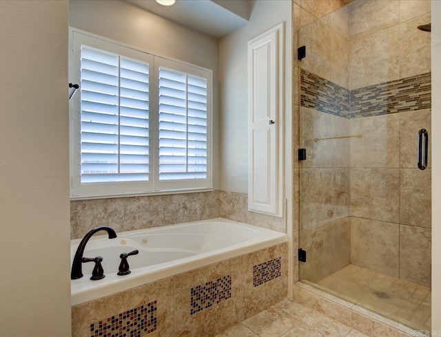 bathroom with separate shower and tub and tile patterned floors