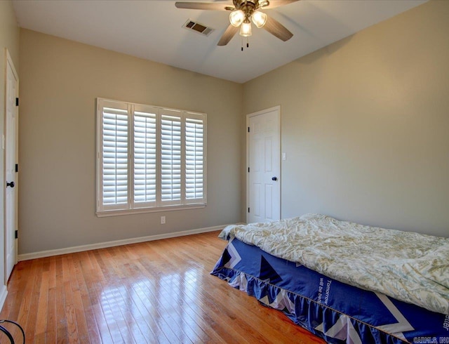 bedroom with hardwood / wood-style floors and ceiling fan